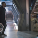 Michael Burnham and Book (carrying Grudge the Cat in a futuristic carrier) cross paths in a corridor on the Discovery.